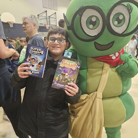 un élève avec notre mascotte Camille La chenille